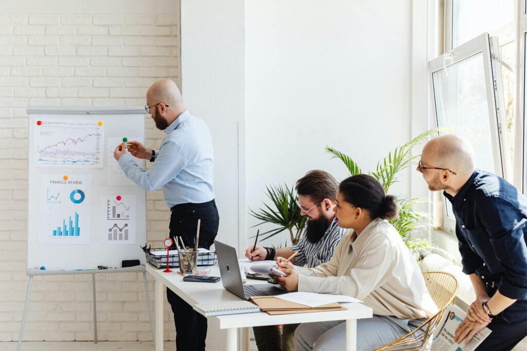 Team discussing marketing strategy with charts and financial data in a modern office